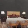 Cozy bedroom with patterned cushions and lamps.