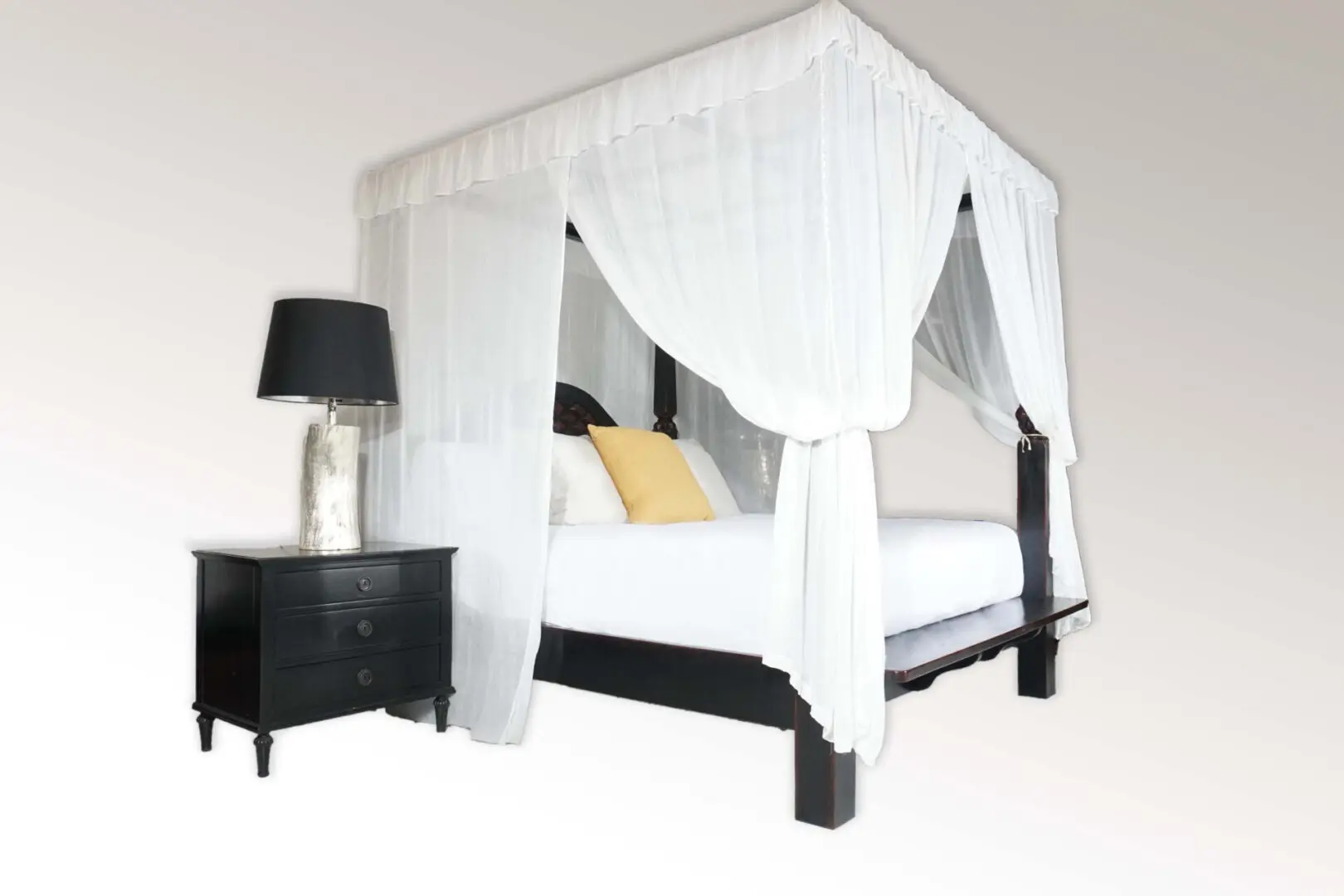 Canopy bed with white curtains and nightstand.