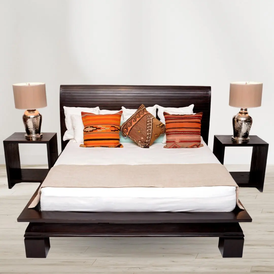 Dark wood platform bed with patterned pillows.