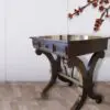 Dark wood console table with ornate legs.