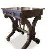 Wooden table with decorative curved legs.
