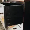 Open drawer in wooden cabinet.
