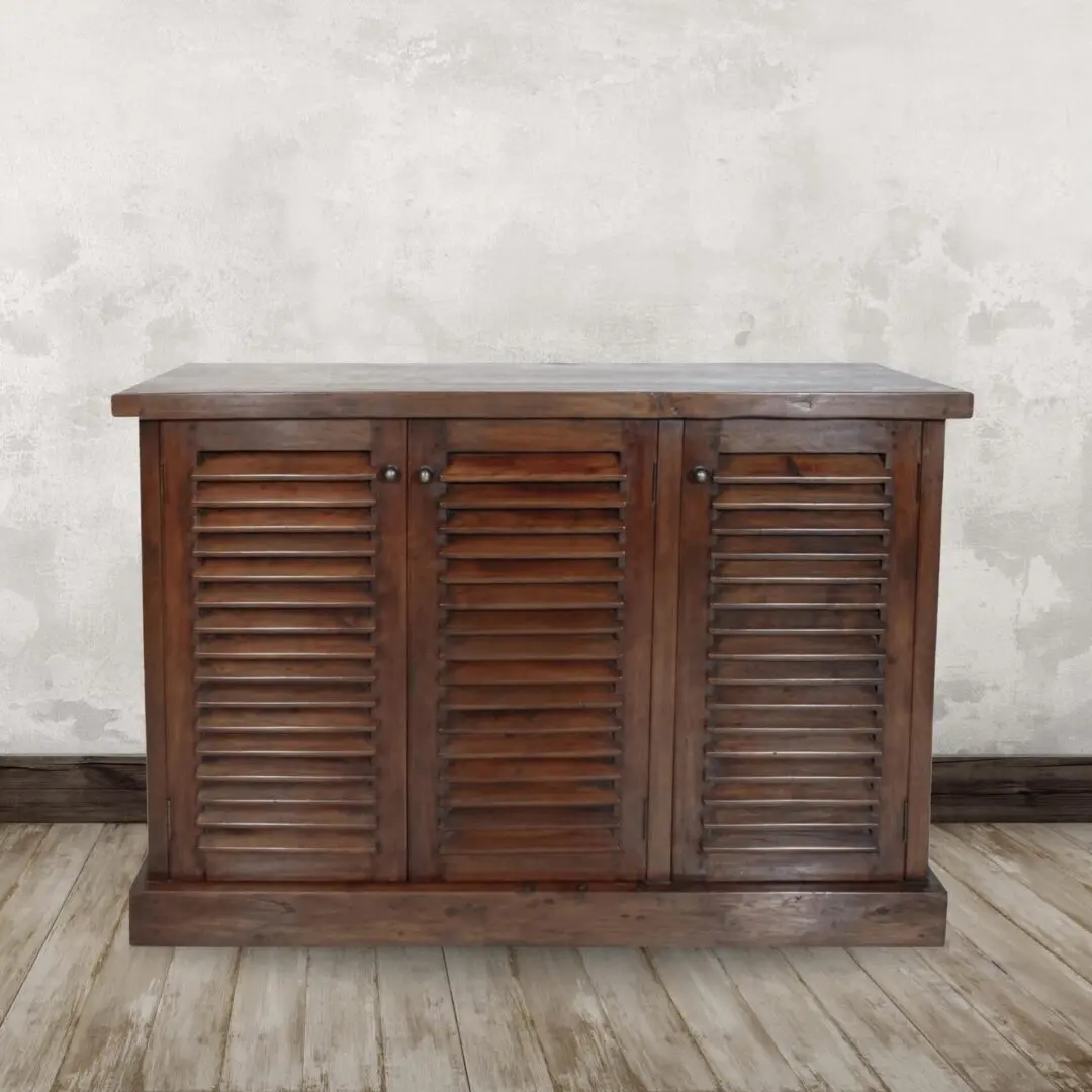 Wooden cabinet with three louvered doors.