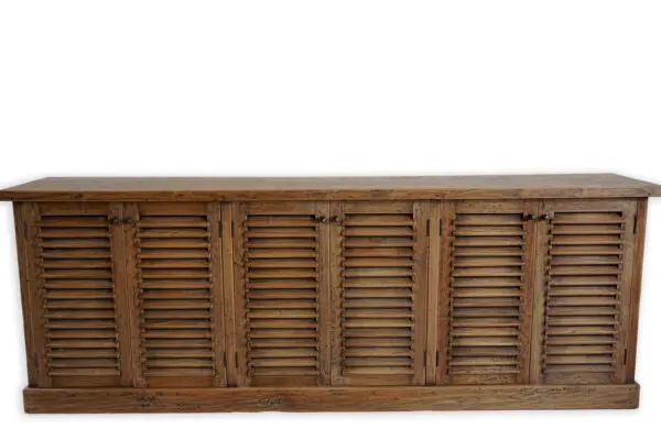 Wooden cabinet with louvered doors.