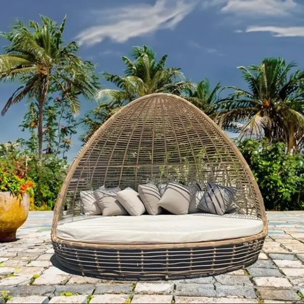 Stylish outdoor seating surrounded by palm trees.