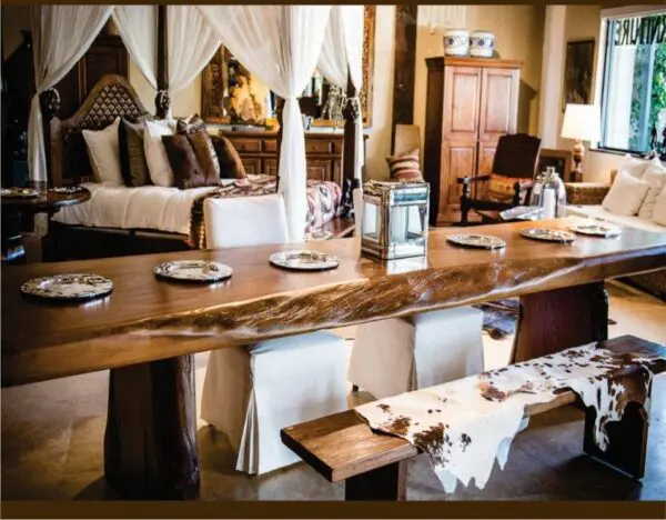 A dining room table with plates and silverware on it.