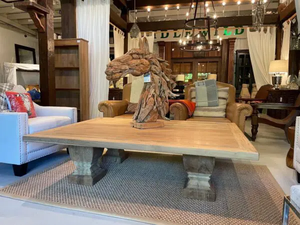 A large wooden table in the middle of a room.