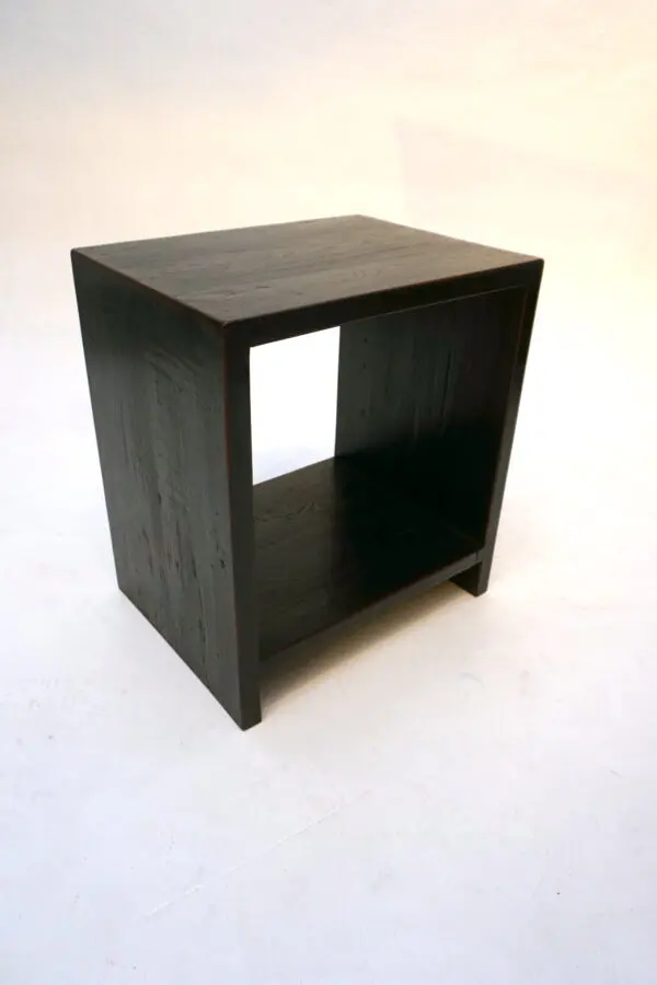 Black wooden side table with open compartment.