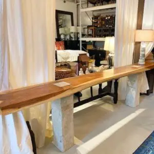 A long table with two pillars and wooden top.