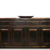 A black and brown wooden cabinet with drawers.