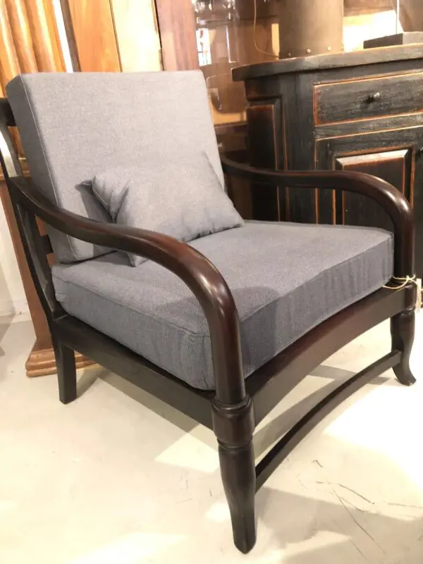 A chair with grey cushion and wooden frame.