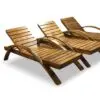 Three wooden lounge chairs in a row.