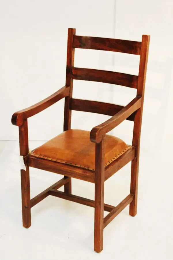 Wooden chair with leather seat and armrests.