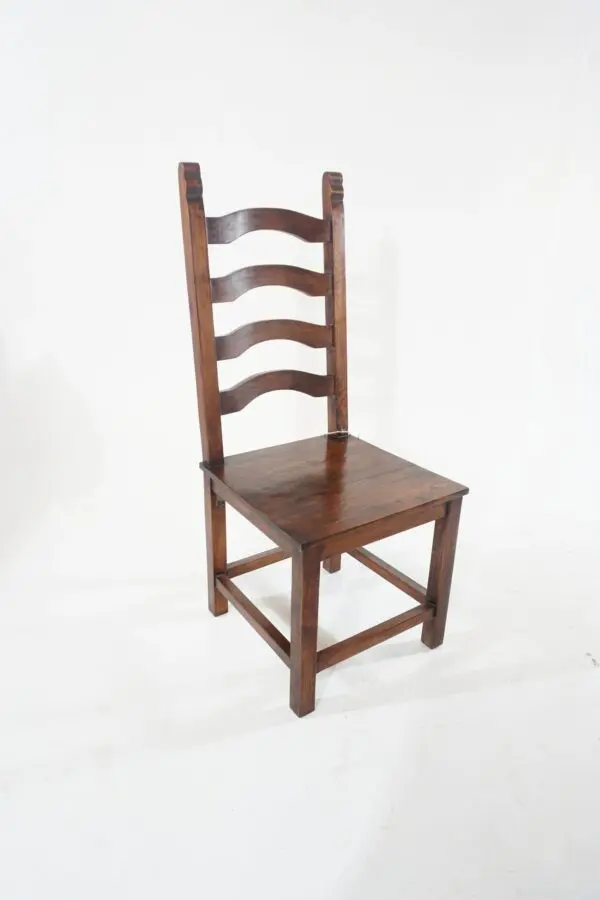 A wooden chair with a brown seat and back.