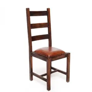 A wooden chair with brown leather seat.