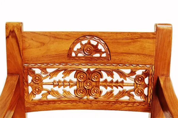 A wooden carved wall hanging with intricate carvings.