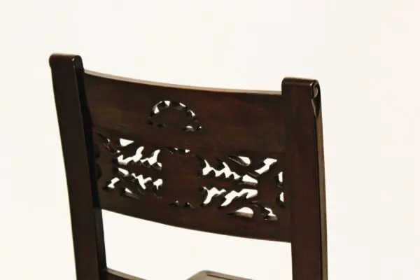 A close up of the back of a wooden chair