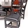 A wooden table with chairs and a black chair