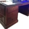 Wooden desk with drawers and workspace.