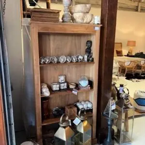 Wooden shelf with decorative items and lanterns.