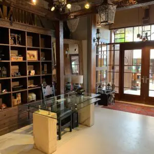 Modern interior with wooden shelves and glass table.