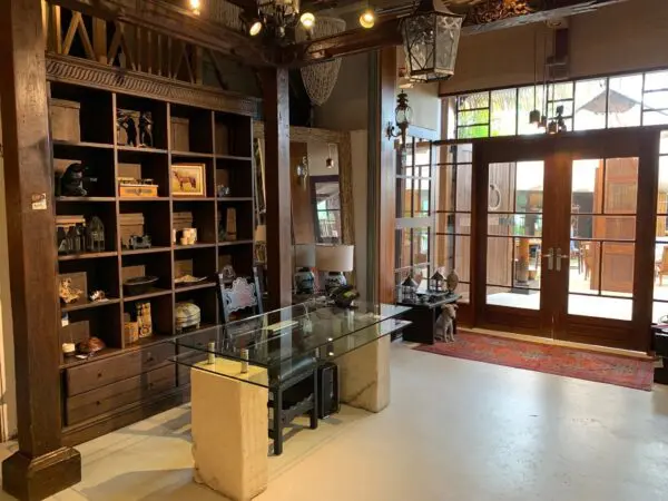 Modern interior with wooden shelves and glass table.