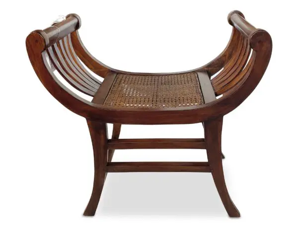 Wooden bench with curved design and cane seating.