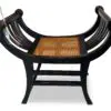 Wooden bench with curved back and cane seat.