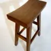 Wooden stool with a curved seat design.