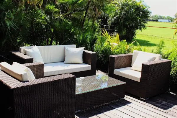 Outdoor seating area with green plants.