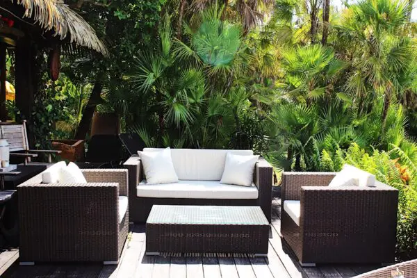 Cozy outdoor seating area surrounded by greenery.