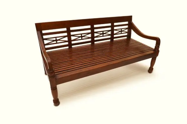 Wooden bench with decorative backrest design.