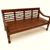 Wooden bench with decorative backrest design.