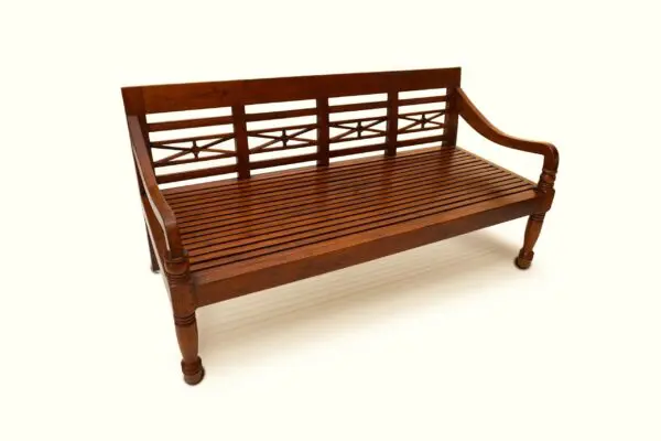 Wooden bench with decorative backrest design.