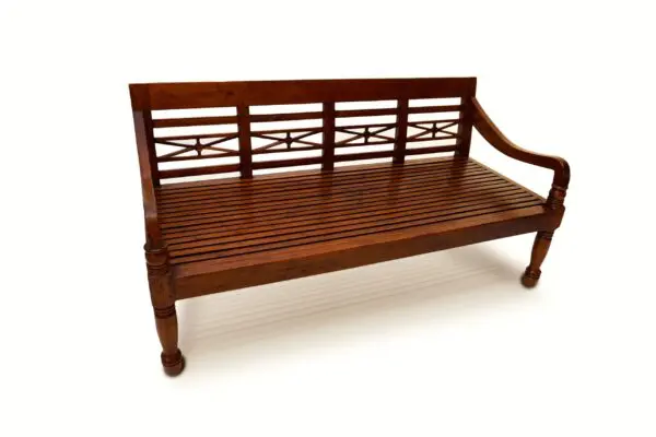 Wooden bench with decorative backrest design.