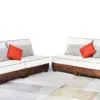 Two couches with pillows on a tile floor.