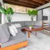 A couch and table in a room with plants.