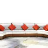 A couch with pillows on it sitting in front of a wall.