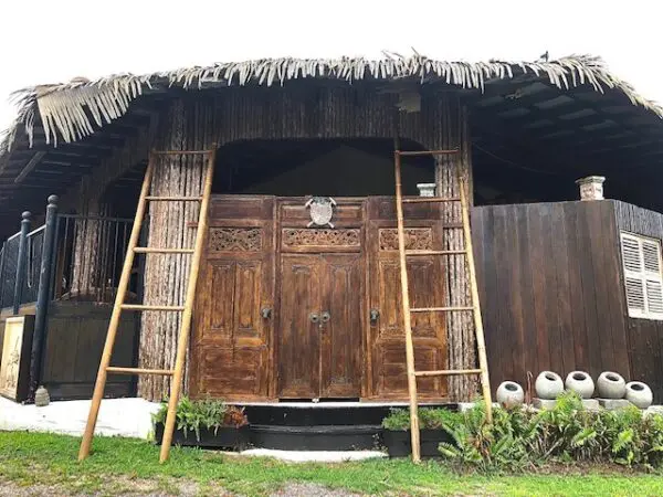 A wooden door with two ladders on the side of it.