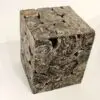 Abstract textured cube with layered design.
