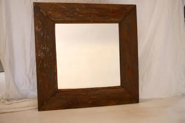 Large wooden-framed mirror against white background.