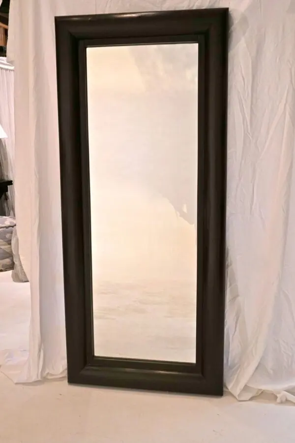 Large rectangular mirror with dark frame.