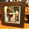 Decorative mirror with wooden frame design.