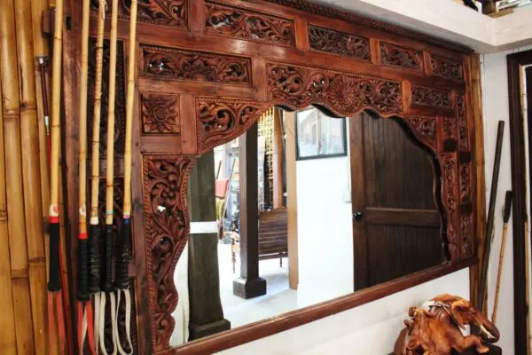 Ornate wooden mirror with decorative carvings.