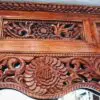 Intricate wooden carving with floral patterns.