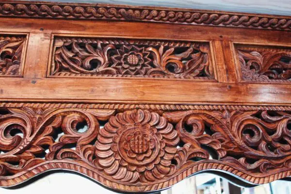 Intricate wooden carving with floral patterns.