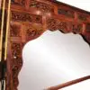 Ornate wooden mirror with decorative carvings.