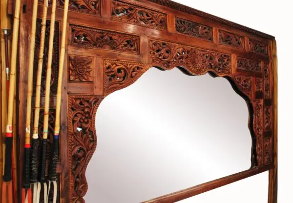 Ornate wooden mirror with decorative carvings.