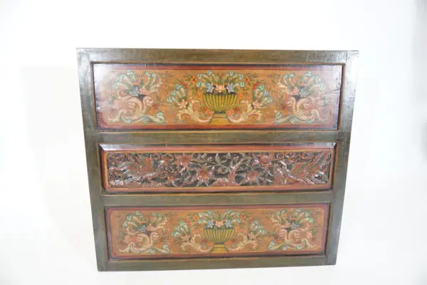 Decorative wooden chest with floral carvings.