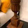 Wooden lamp base with decorative elements.
